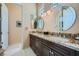 Bathroom features a double sink vanity with granite counters, decorative mirrors, and tile flooring at 4564 Bersaglio St, Las Vegas, NV 89135