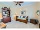 Cozy bedroom featuring a daybed, dark wood furniture, a ceiling fan, and neutral color palette at 4564 Bersaglio St, Las Vegas, NV 89135