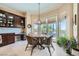 Bright breakfast nook features built in cabinets, round table and seating, and views of the backyard and outdoor area at 4564 Bersaglio St, Las Vegas, NV 89135