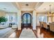 Elegant entryway with dark wood floors, decorative front door, and views into the living and dining areas at 4564 Bersaglio St, Las Vegas, NV 89135