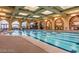 Stunning indoor pool with marked lanes, arched windows and ornate decorative murals at 4564 Bersaglio St, Las Vegas, NV 89135
