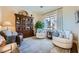 Cozy living room featuring comfortable seating, a large window, and built in bookcase at 4564 Bersaglio St, Las Vegas, NV 89135