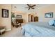 Spacious primary bedroom with sitting area, neutral color palette, ceiling fan and ensuite bathroom at 4564 Bersaglio St, Las Vegas, NV 89135