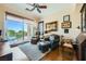 Bright and airy sitting room with a sliding glass door, comfortable seating, and a desk area at 4564 Bersaglio St, Las Vegas, NV 89135