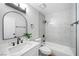 Bright bathroom with a vanity with marble countertops, a shower head, and tiled walls at 5060 Jeffreys St # 201, Las Vegas, NV 89119