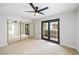 Bedroom with ceiling fan, closet with sliding mirror doors, and balcony entrance at 5060 Jeffreys St # 201, Las Vegas, NV 89119