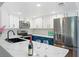 Modern kitchen with white cabinets, stainless steel appliances, and marble countertops at 5060 Jeffreys St # 201, Las Vegas, NV 89119