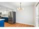 Bright kitchen with stainless steel refrigerator, island, and modern chandelier at 5060 Jeffreys St # 201, Las Vegas, NV 89119