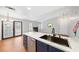 Kitchen view with island featuring a dark sink and white marble countertops at 5060 Jeffreys St # 201, Las Vegas, NV 89119