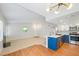 Open concept living room with fireplace, kitchen, and decorative window at 5060 Jeffreys St # 201, Las Vegas, NV 89119