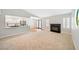 Open-concept living room with fireplace, hardwood floors, and updated kitchen views at 5060 Jeffreys St # 201, Las Vegas, NV 89119