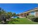 Lush backyard with well-manicured artificial lawn, desert landscaping and a sparkling pool at 5416 Alabaster Ct, Las Vegas, NV 89149