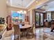 Bright dining room with unique light fixture and an oversized window with backyard views at 5416 Alabaster Ct, Las Vegas, NV 89149