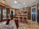 Gourmet kitchen featuring stainless steel appliances, a breakfast bar, and custom wood cabinetry at 5416 Alabaster Ct, Las Vegas, NV 89149