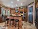 Gourmet kitchen featuring stainless steel appliances, a breakfast bar, and custom wood cabinetry at 5416 Alabaster Ct, Las Vegas, NV 89149