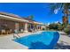 Back exterior of home showcasing private pool with well-maintained landscaping and covered seating area at 5416 Alabaster Ct, Las Vegas, NV 89149
