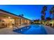 A pristine backyard pool sparkles at twilight, enhanced by manicured landscaping and towering palm trees at 5416 Alabaster Ct, Las Vegas, NV 89149