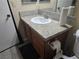 Bathroom features a white sink with granite countertop, wood cabinets, and new fixtures at 5419 Centurion Ct # 102, Las Vegas, NV 89122