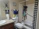 Cozy bathroom with a granite vanity top, shower with a shower curtain, a tiled shower, and white toilet at 5419 Centurion Ct # 102, Las Vegas, NV 89122