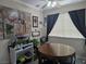 This dining area features a wood table and chairs set next to a large window and modern artwork at 5419 Centurion Ct # 102, Las Vegas, NV 89122