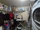 Functional laundry room featuring a washer and dryer, along with storage shelves and a hanging rack at 5419 Centurion Ct # 102, Las Vegas, NV 89122