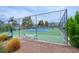 Outdoor tennis court is fenced for privacy and safety and has bench for relaxing between sets at 5419 Centurion Ct # 102, Las Vegas, NV 89122