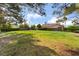 Lush backyard featuring a green lawn and mature trees, offering a private outdoor space at 5532 Sentinel Bridge St, Las Vegas, NV 89130
