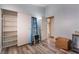 Bedroom with laminate floors, storage shelves, closet, and blue accent wall, offering ample storage space at 5532 Sentinel Bridge St, Las Vegas, NV 89130