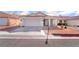 Inviting single-story home featuring a two-car garage and mature landscaping at 5532 Sentinel Bridge St, Las Vegas, NV 89130