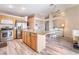 Open kitchen with stainless appliances, center island, and seamless flow to dining area at 5532 Sentinel Bridge St, Las Vegas, NV 89130
