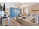 Spacious living room with comfortable sectional, wood-look floors, and access to dining area at 5532 Sentinel Bridge St, Las Vegas, NV 89130