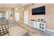 Open-concept living area with a modern media console, wood-look flooring, and neutral colors at 5532 Sentinel Bridge St, Las Vegas, NV 89130
