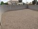 Spacious backyard featuring gravel landscaping enclosed with tall block wall at 600 Sarajane Ln, Las Vegas, NV 89107