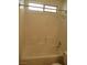 Bathtub and shower with tile surround and a window at 600 Sarajane Ln, Las Vegas, NV 89107