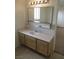 Bathroom vanity with light wood cabinets, light countertop, and lighted mirror at 600 Sarajane Ln, Las Vegas, NV 89107