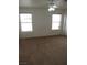 Bedroom with neutral carpet, two windows, and a ceiling fan with light at 600 Sarajane Ln, Las Vegas, NV 89107