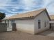 Side view of a single story home featuring a tile roof, stucco exterior, and rock landscaping at 600 Sarajane Ln, Las Vegas, NV 89107