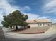 Charming single-story home with a tile roof, low maintenance landscaping, and mature shade tree at 600 Sarajane Ln, Las Vegas, NV 89107