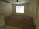 Cozy living room featuring neutral carpeting, a ceiling fan, and a front door at 600 Sarajane Ln, Las Vegas, NV 89107