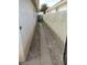Side yard featuring a narrow pathway with gravel, tall walls, and minimal landscaping at 600 Sarajane Ln, Las Vegas, NV 89107