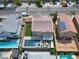 Stunning aerial view of a home with a backyard oasis including a pool, lounge area, and manicured landscaping at 6142 W Levi Ave, Las Vegas, NV 89141