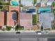 Overhead view of a home with a pool and landscaping in a neighborhood with nearby street parking at 6142 W Levi Ave, Las Vegas, NV 89141