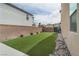 Spacious backyard featuring lush turf, landscaping, and gravel areas for low-maintenance living at 6142 W Levi Ave, Las Vegas, NV 89141