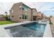 Backyard with pool, tanning ledge, turf, and patio with outdoor kitchen, ideal for entertaining at 6142 W Levi Ave, Las Vegas, NV 89141