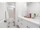 Bright bathroom featuring double sinks with storage, a large mirror, and a separate shower and toilet at 6142 W Levi Ave, Las Vegas, NV 89141