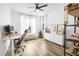 Bright bedroom featuring a large desk area, daybed, light wood floors, and stylish modern decor at 6142 W Levi Ave, Las Vegas, NV 89141