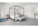 Bright bedroom features a four-poster bed, carpet, and neutral color palette at 6142 W Levi Ave, Las Vegas, NV 89141