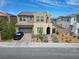Two-story home featuring a stucco facade, desert landscaping, two-car garage and arched entry at 6142 W Levi Ave, Las Vegas, NV 89141