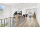 Bright hallway features hardwood floors, modern railing and light-filled living spaces at 6142 W Levi Ave, Las Vegas, NV 89141