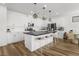 Spacious kitchen boasts a central island with bar seating and modern light fixtures at 6142 W Levi Ave, Las Vegas, NV 89141